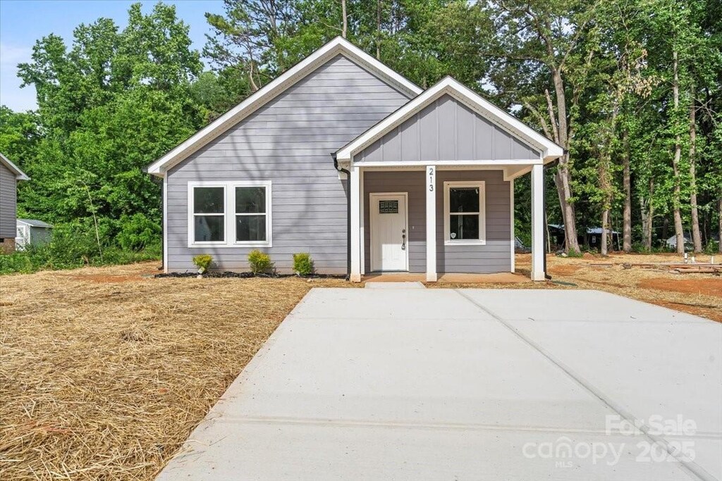 213 E Division Ave, East Spencer, NC 28039 - view of front facade featuring board and batten siding and a porch