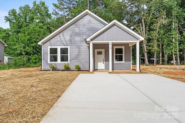 213 E Division Ave, East Spencer, NC 28039 - view of front facade featuring board and batten siding and a porch