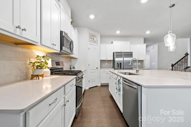 12637 Belmont Mansion Dr, Charlotte, NC 28273 - kitchen featuring stainless steel appliances, a sink, backsplash, white cabinetry, and light countertops