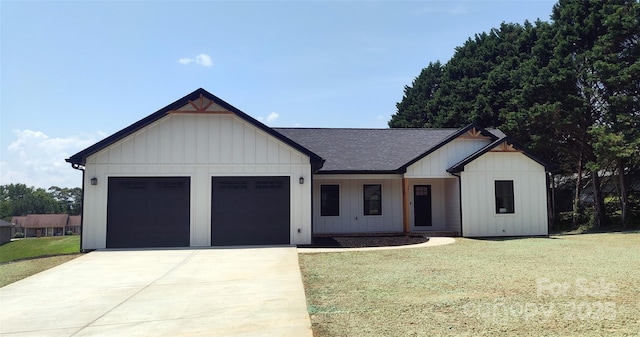 4364 Grover Pl, Granite Falls, NC 28630 - modern inspired farmhouse featuring an attached garage, a shingled roof, driveway, a front yard, and board and batten siding