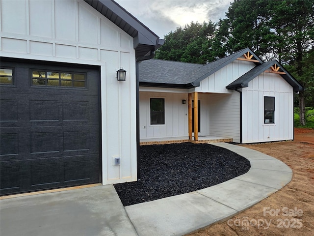 4364 Grover Pl, Granite Falls, NC 28630 - view of exterior entry with board and batten siding, roof with shingles, and an attached garage
