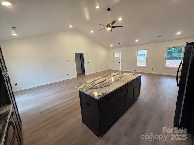 4364 Grover Pl, Granite Falls, NC 28630 - kitchen with freestanding refrigerator, open floor plan, ceiling fan, dark cabinetry, and lofted ceiling