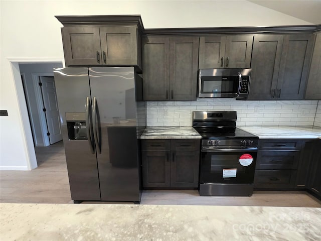 4364 Grover Pl, Granite Falls, NC 28630 - kitchen featuring stainless steel appliances, light wood-style flooring, dark brown cabinetry, decorative backsplash, and lofted ceiling