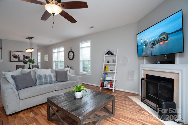 12719 Walking Stick Dr, Charlotte, NC 28278 - living area featuring light wood-style floors, a fireplace with flush hearth, baseboards, and a ceiling fan