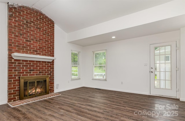 8429 Meadowcroft Ct, Charlotte, NC 28215 - unfurnished living room featuring wood finished floors, vaulted ceiling, a fireplace, and baseboards