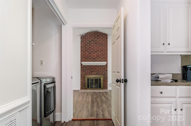 8429 Meadowcroft Ct, Charlotte, NC 28215 - laundry area with separate washer and dryer, dark wood-style flooring, and a brick fireplace