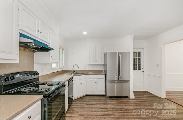 8429 Meadowcroft Ct, Charlotte, NC 28215 - kitchen with freestanding refrigerator, electric range, under cabinet range hood, dishwasher, and dark wood finished floors