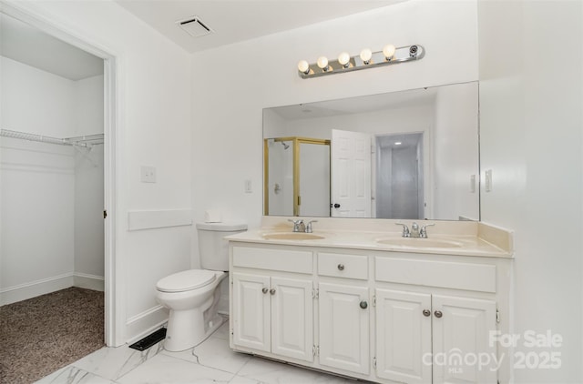 8429 Meadowcroft Ct, Charlotte, NC 28215 - bathroom featuring double vanity, a stall shower, toilet, a spacious closet, and marble finish floors