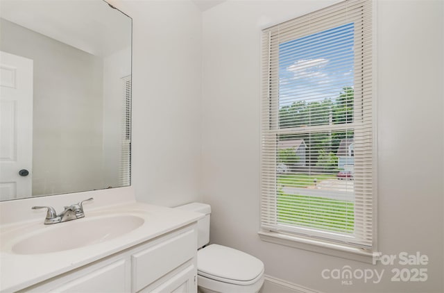 8429 Meadowcroft Ct, Charlotte, NC 28215 - bathroom with toilet, vanity, and baseboards