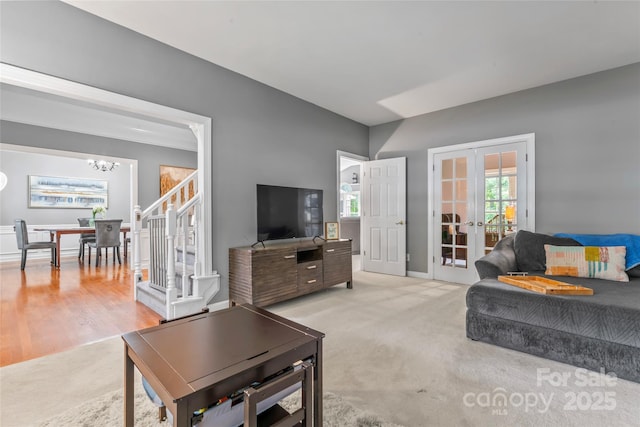 5233 Fairvista Dr, Charlotte, NC 28269 - carpeted living room with french doors, a chandelier, stairway, and baseboards