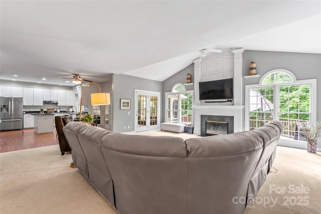 5233 Fairvista Dr, Charlotte, NC 28269 - living area with light colored carpet, ceiling fan, lofted ceiling, healthy amount of natural light, and a large fireplace