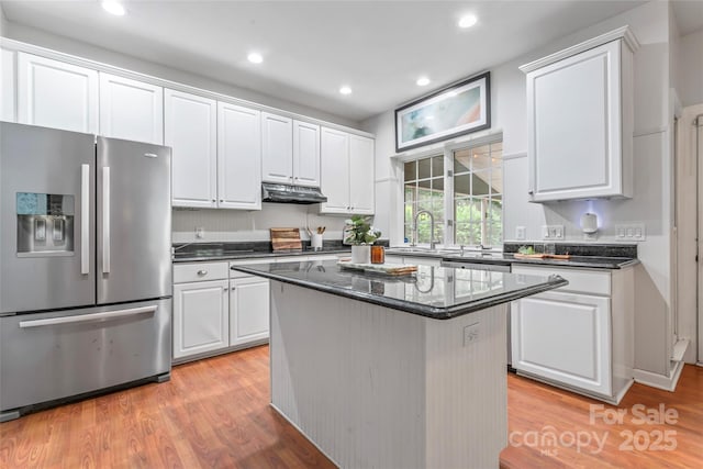 5233 Fairvista Dr, Charlotte, NC 28269 - kitchen featuring stainless steel fridge with ice dispenser, a sink, white cabinets, under cabinet range hood, and light wood finished floors