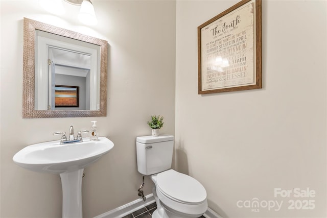 5233 Fairvista Dr, Charlotte, NC 28269 - half bath featuring baseboards, toilet, and tile patterned floors