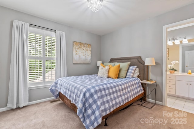 5233 Fairvista Dr, Charlotte, NC 28269 - bedroom with light colored carpet, baseboards, and ensuite bath