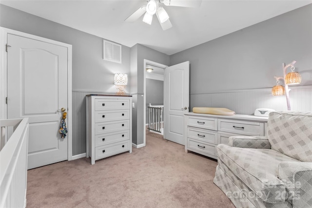 5233 Fairvista Dr, Charlotte, NC 28269 - living area with wainscoting, a ceiling fan, and light carpet