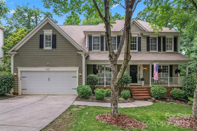 5233 Fairvista Dr, Charlotte, NC 28269 - view of front facade featuring covered porch, driveway, an attached garage, and roof with shingles