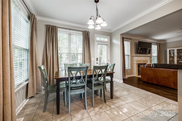 1648 Jonesberry Dr, Rock Hill, SC 29732 - dining space with ornamental molding, light tile patterned flooring, a fireplace, baseboards, and a chandelier
