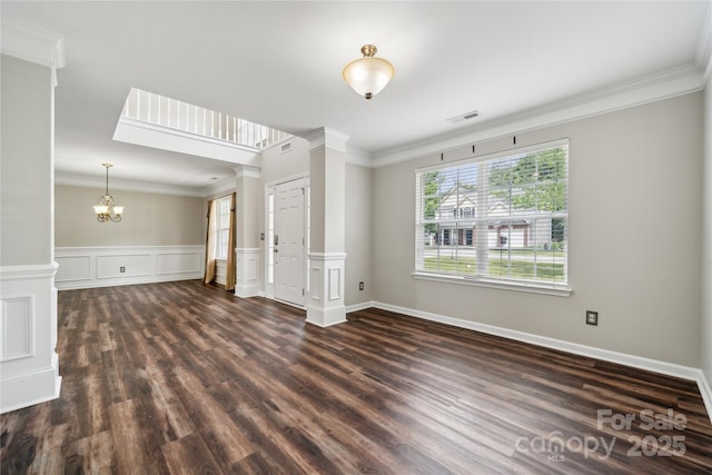 2028 Covered Bridge Ct, Rock Hill, SC 29732 - unfurnished living room featuring dark wood-style flooring, ornamental molding, ornate columns, and a chandelier