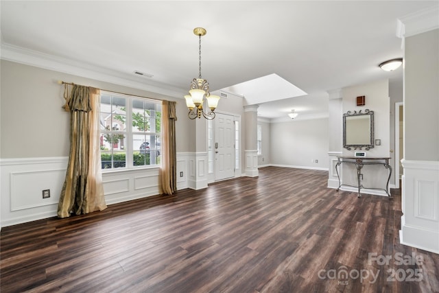 2028 Covered Bridge Ct, Rock Hill, SC 29732 - unfurnished living room featuring a chandelier, crown molding, dark wood-style flooring, wainscoting, and a decorative wall