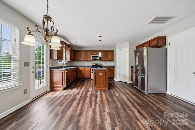 2028 Covered Bridge Ct, Rock Hill, SC 29732 - kitchen with stainless steel appliances, dark wood finished floors, dark countertops, and a center island