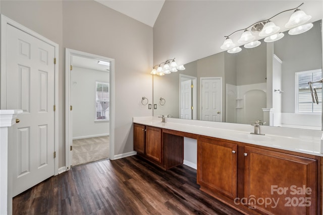2028 Covered Bridge Ct, Rock Hill, SC 29732 - bathroom with wood finished floors, high vaulted ceiling, double vanity, plenty of natural light, and baseboards