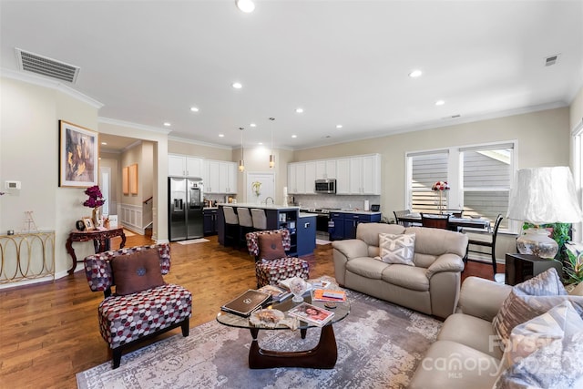 19004 Dry Narrows Way, Charlotte, NC 28278 - living room with wood finished floors, crown molding, and recessed lighting
