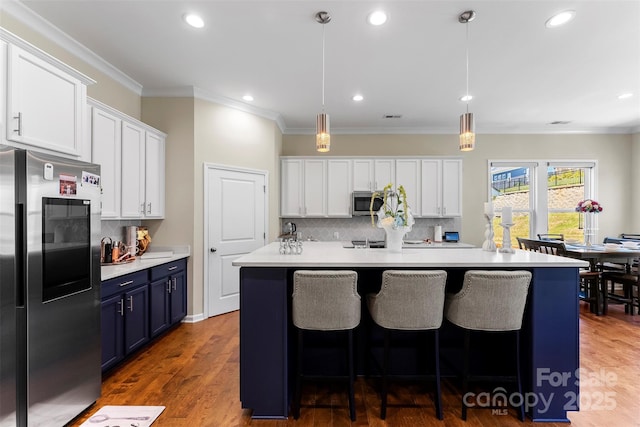 19004 Dry Narrows Way, Charlotte, NC 28278 - kitchen with stainless steel appliances, blue cabinetry, backsplash, white cabinets, and light countertops
