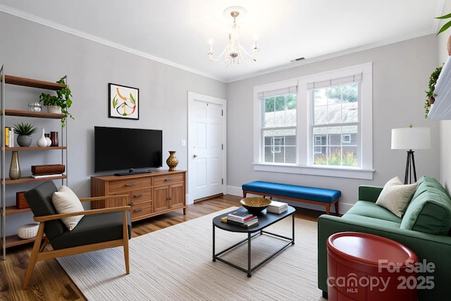 524 Hawthorne Ln, Charlotte, NC 28204 - living area featuring wood finished floors, a chandelier, ornamental molding, and baseboards
