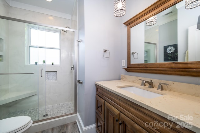 524 Hawthorne Ln, Charlotte, NC 28204 - bathroom with toilet, vanity, a shower stall, baseboards, and a chandelier