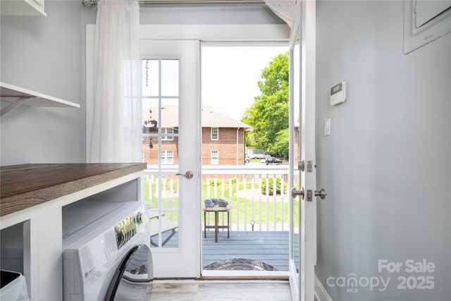 524 Hawthorne Ln, Charlotte, NC 28204 - doorway featuring french doors, washer / clothes dryer, and wood finished floors