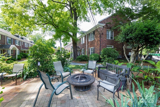 524 Hawthorne Ln, Charlotte, NC 28204 - view of patio featuring an outdoor fire pit and a residential view