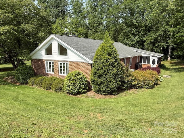 3586 US-70 Rd W, Marion, NC 28752 - view of home's exterior with brick siding, a yard, roof with shingles, and view of wooded area