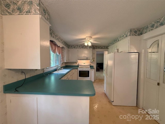 3586 US-70 Rd W, Marion, NC 28752 - kitchen with white appliances, ceiling fan, a peninsula, a sink, and a textured ceiling
