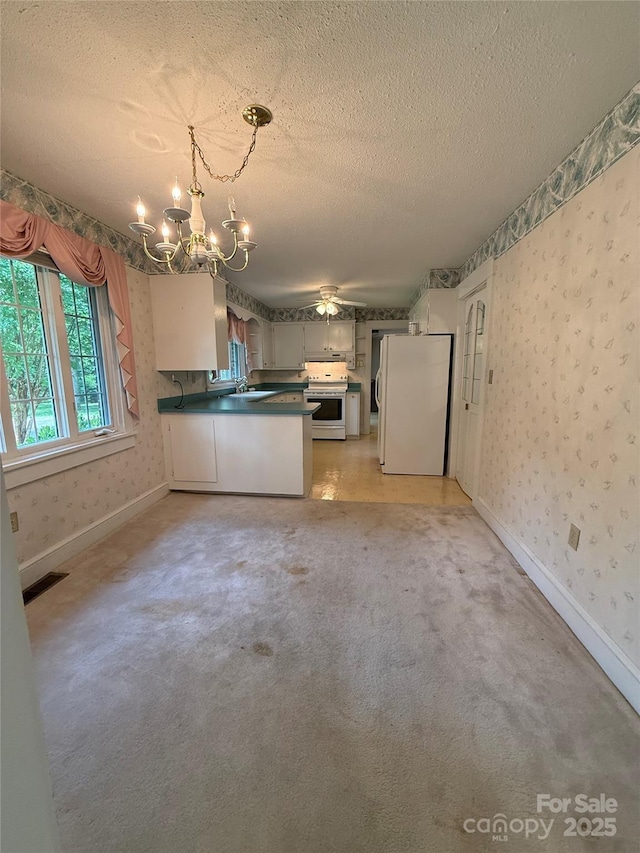 3586 US-70 Rd W, Marion, NC 28752 - kitchen featuring freestanding refrigerator, electric range, a chandelier, dark countertops, and wallpapered walls