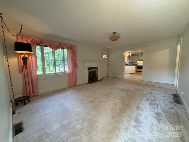3586 US-70 Rd W, Marion, NC 28752 - unfurnished living room featuring a fireplace, light carpet, baseboards, and a chandelier