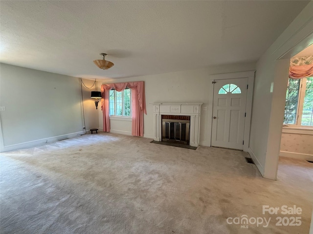 3586 US-70 Rd W, Marion, NC 28752 - unfurnished living room with light carpet, a fireplace with flush hearth, baseboards, and a textured ceiling