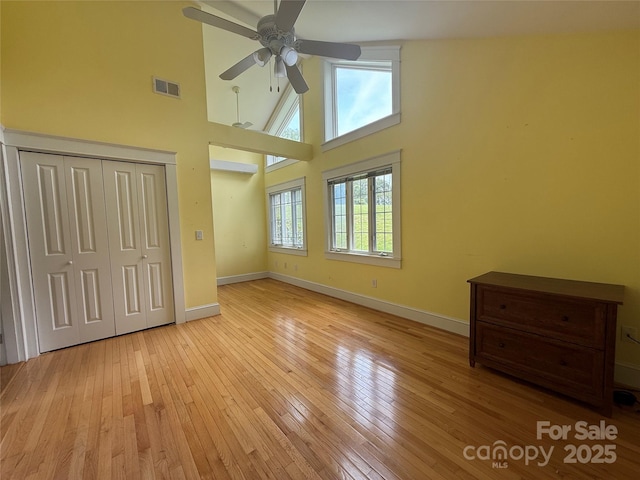 3586 US-70 Rd W, Marion, NC 28752 - unfurnished bedroom featuring a towering ceiling, baseboards, light wood-style floors, and a closet