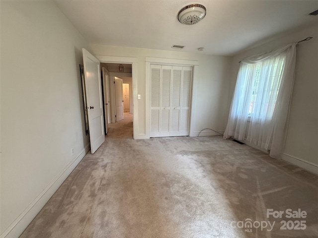 3586 US-70 Rd W, Marion, NC 28752 - unfurnished bedroom featuring light carpet, a closet, and baseboards