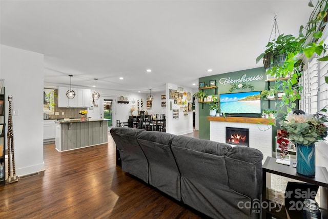 7921 Willhill Rd, Mint Hill, NC 28227 - living area featuring dark wood finished floors, recessed lighting, a brick fireplace, and baseboards