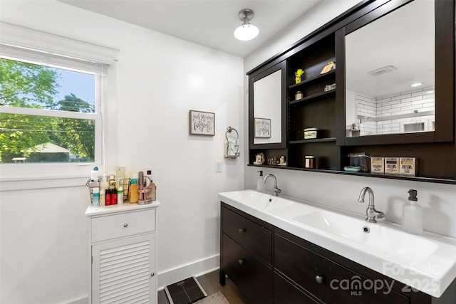 7921 Willhill Rd, Mint Hill, NC 28227 - bathroom with double vanity, baseboards, and wood finished floors
