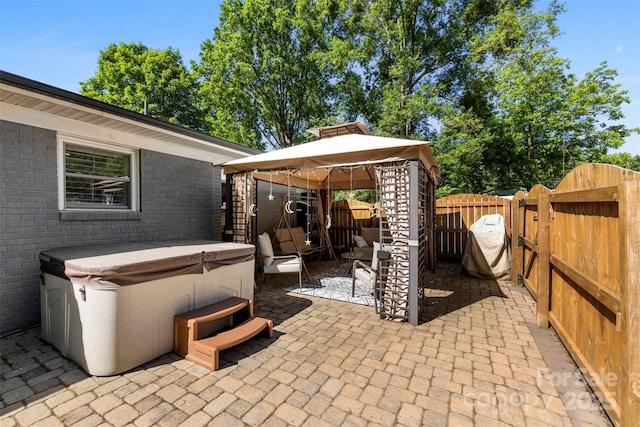 7921 Willhill Rd, Mint Hill, NC 28227 - fenced backyard with a hot tub, a gazebo, a patio area, and a gate