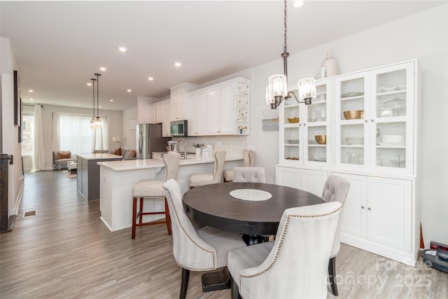 628 Uwharrie River Rd, Charlotte, NC 28211 - dining area with a chandelier, light wood-style floors, and recessed lighting