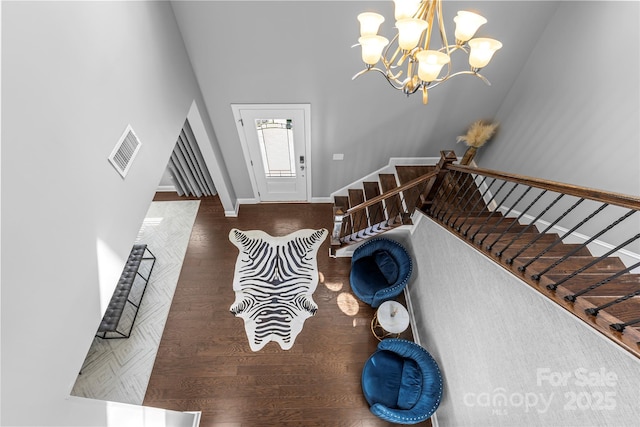 11209 Flenniken Ct, Charlotte, NC 28277 - living area featuring baseboards, a chandelier, wood finished floors, stairs, and a towering ceiling