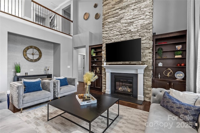 11209 Flenniken Ct, Charlotte, NC 28277 - living area with a glass covered fireplace, wood finished floors, built in features, and a towering ceiling