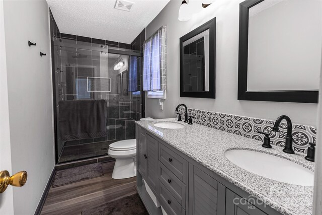 532 Jedburgh Way, Rock Hill, SC 29730 - bathroom featuring double vanity, toilet, a shower stall, a textured ceiling, and wood finished floors