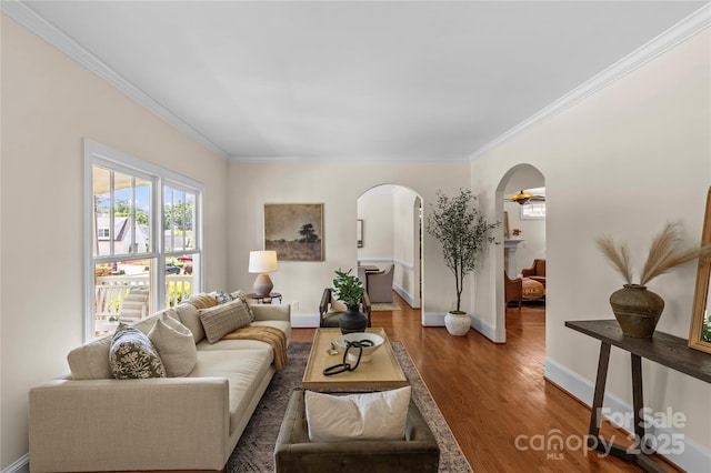 1500 Lynway Dr, Charlotte, NC 28203 - living area with arched walkways, crown molding, wood finished floors, and baseboards