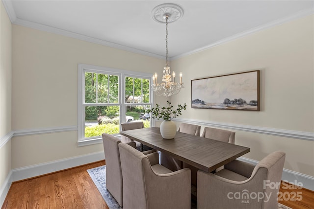 1500 Lynway Dr, Charlotte, NC 28203 - dining room featuring a chandelier, healthy amount of natural light, ornamental molding, baseboards, and wood finished floors