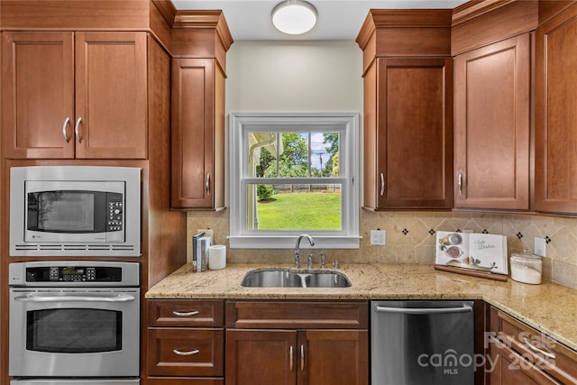 1500 Lynway Dr, Charlotte, NC 28203 - kitchen with stainless steel appliances, a sink, tasteful backsplash, and light stone countertops