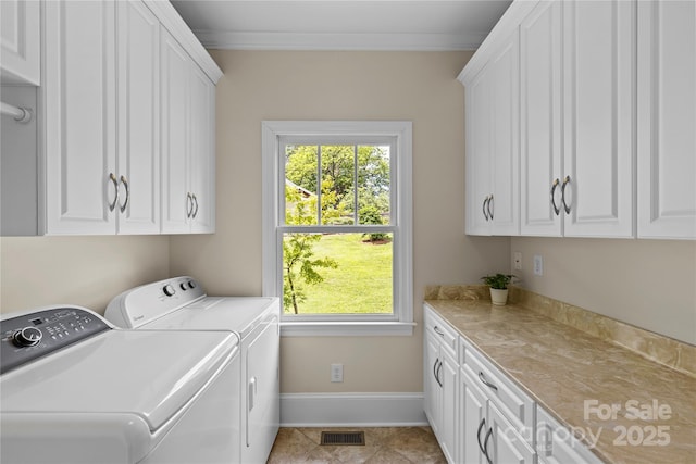 1500 Lynway Dr, Charlotte, NC 28203 - washroom featuring cabinet space, washer and dryer, ornamental molding, plenty of natural light, and baseboards