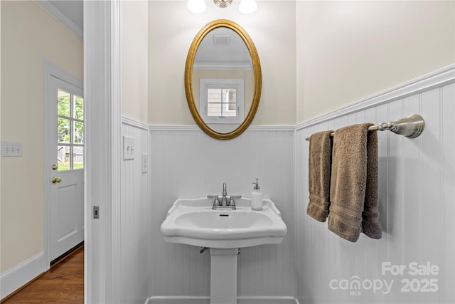 1500 Lynway Dr, Charlotte, NC 28203 - bathroom with a wainscoted wall, wood finished floors, and crown molding